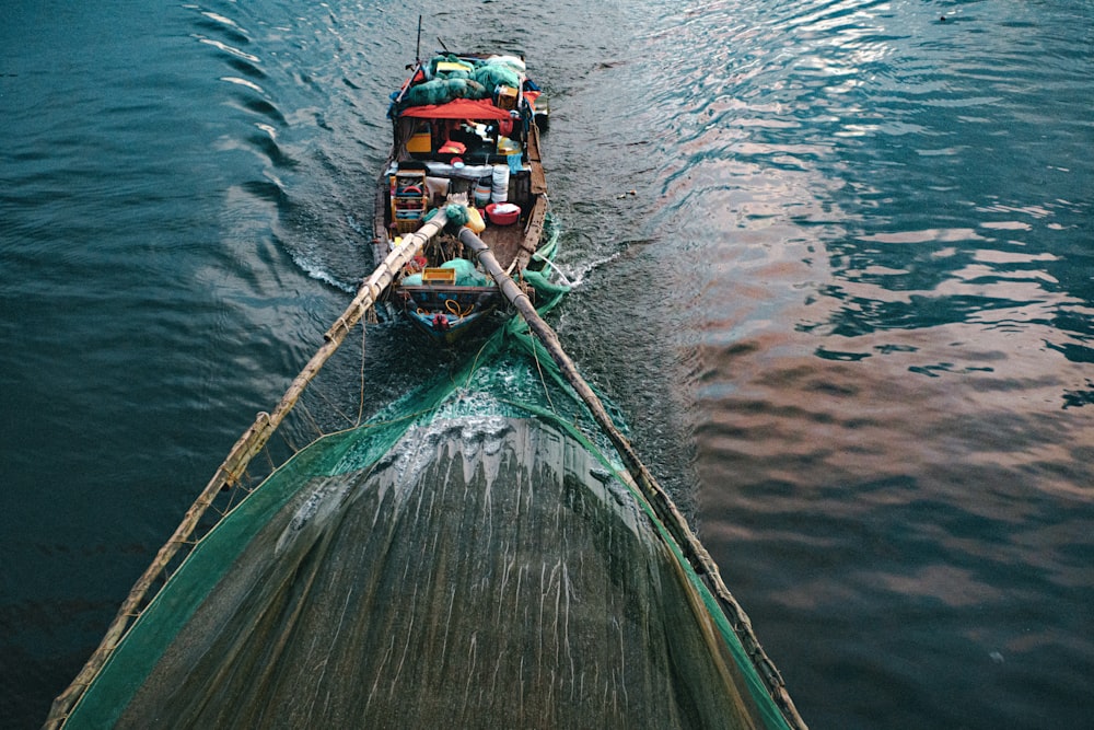 a boat with a lot of stuff on it in the water