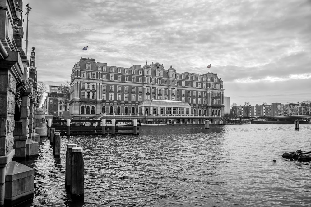 a black and white photo of a river and buildings