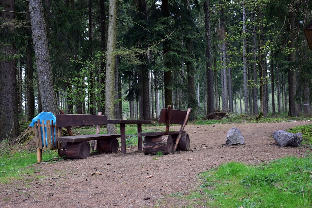 a wooden bench sitting in the middle of a forest