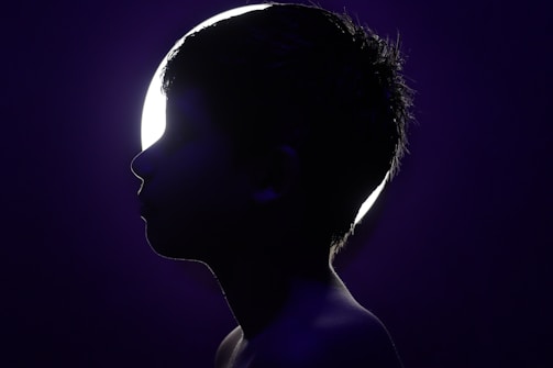 Elegant sketch of a child’s silhouette framed by soft shadows on an off-white background.