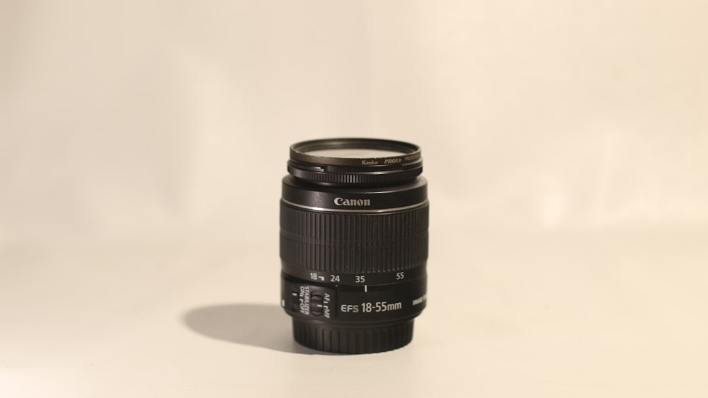 a camera lens sitting on a white surface
