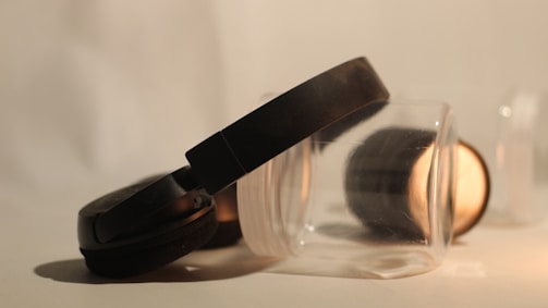 Close-up of headphones resting on an open book with soft lighting.