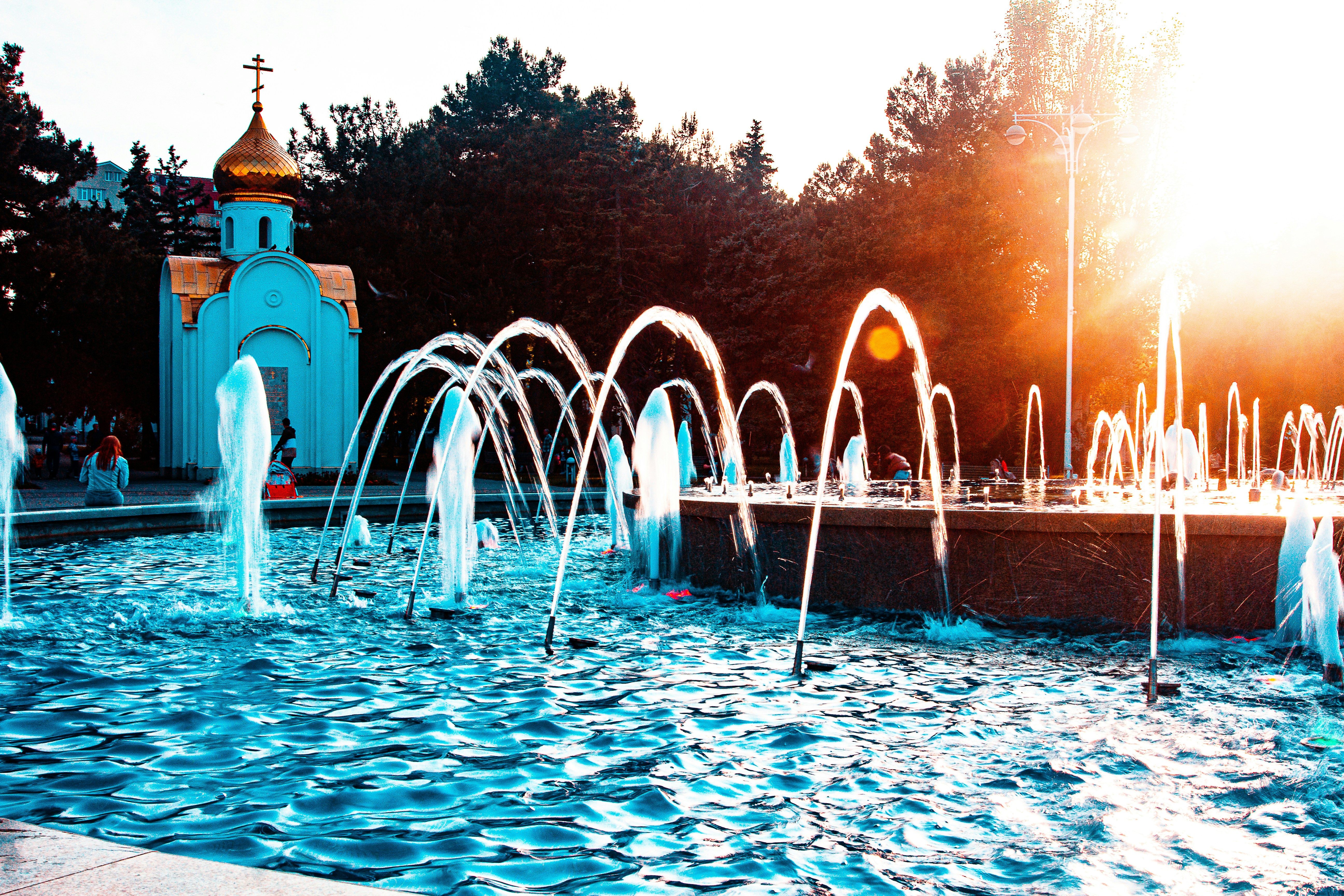 a water fountain with a church in the background
