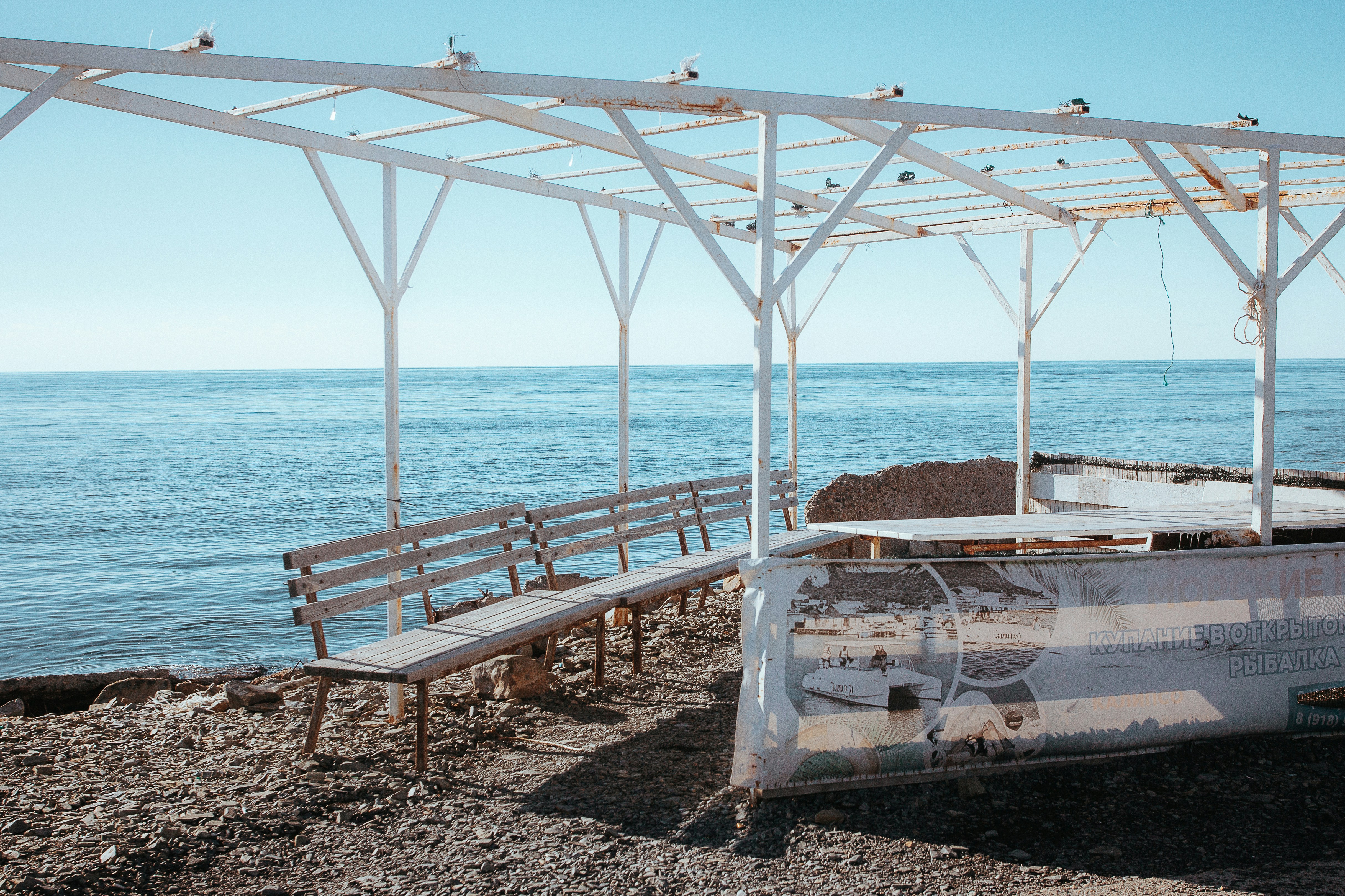 a wooden bench sitting next to the ocean