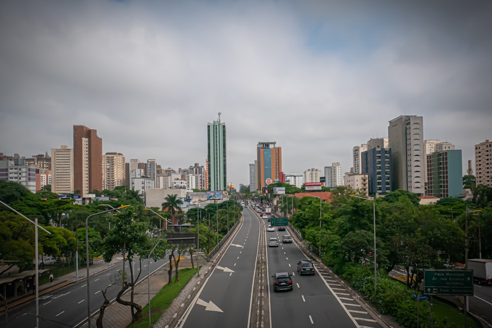 a view of a city street with tall buildings in the background