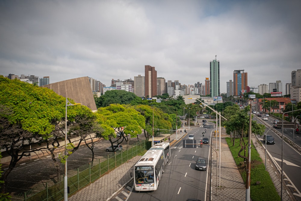 a city street filled with lots of traffic next to tall buildings