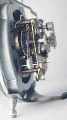 Close-up of vintage clockwork gears turning under the light of a rising sun.