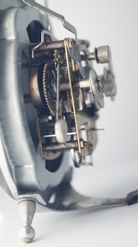 Close-up of vintage clockwork gears turning under the light of a rising sun.