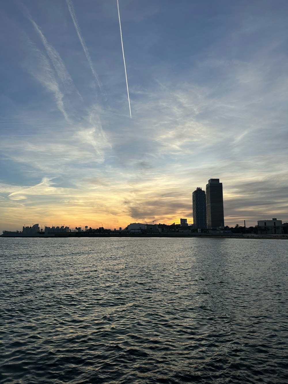 a body of water with buildings in the background