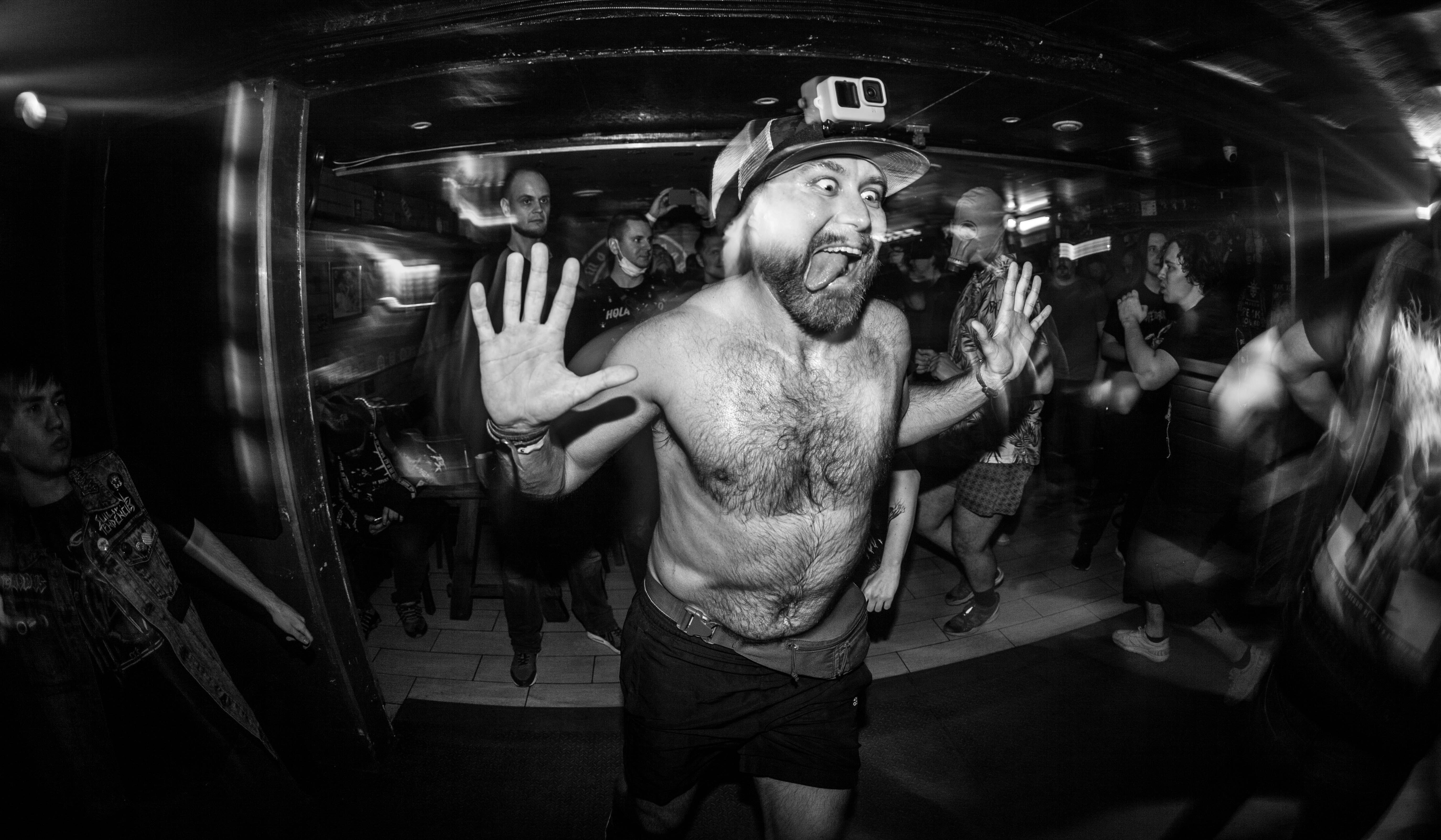 a shirtless man is dancing at a party