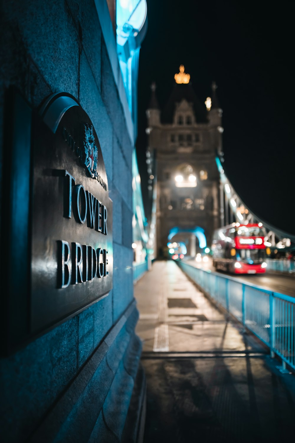 the tower bridge sign is lit up at night