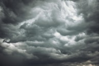 Dark storm clouds rolling in, signaling an approaching thunderstorm.