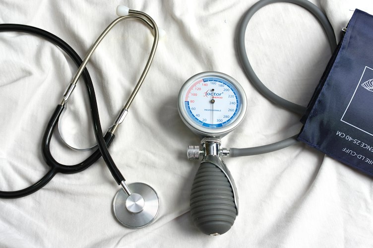 Older adult having a blood pressure check during a routine doctor visit
