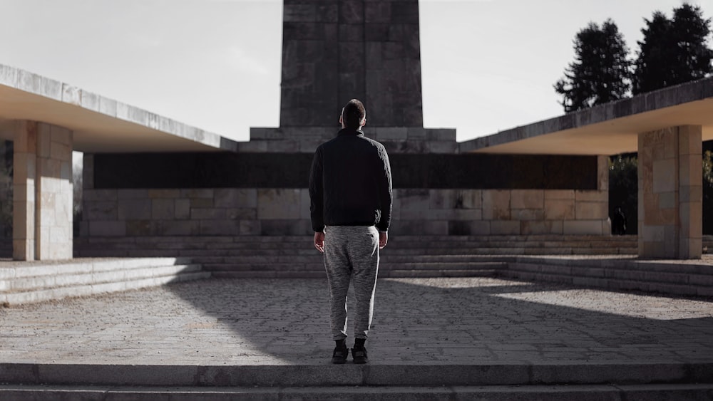 a man standing in front of a monument