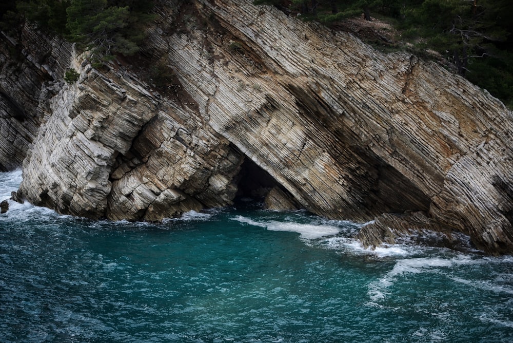 a rock outcropping in the middle of a body of water