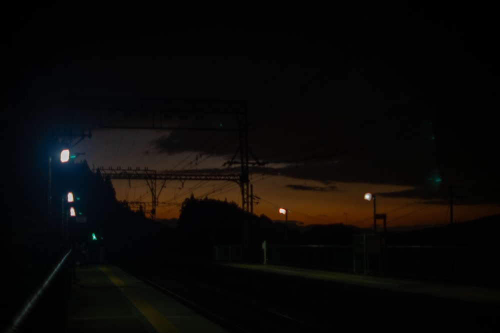 a train traveling down train tracks at night