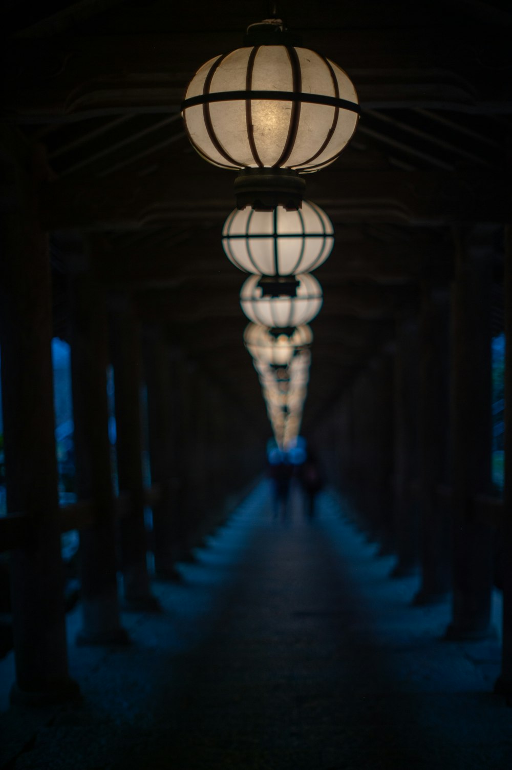 a couple of lights hanging from the ceiling of a building