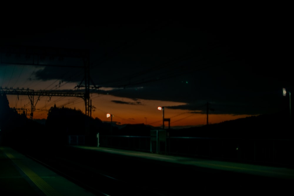 a train traveling down train tracks at night