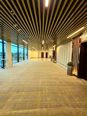 Wide shot of a hallway with vertical prints of forest trees creating depth.