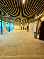 Before and after shots of a common area refreshed with new flooring and lighting.