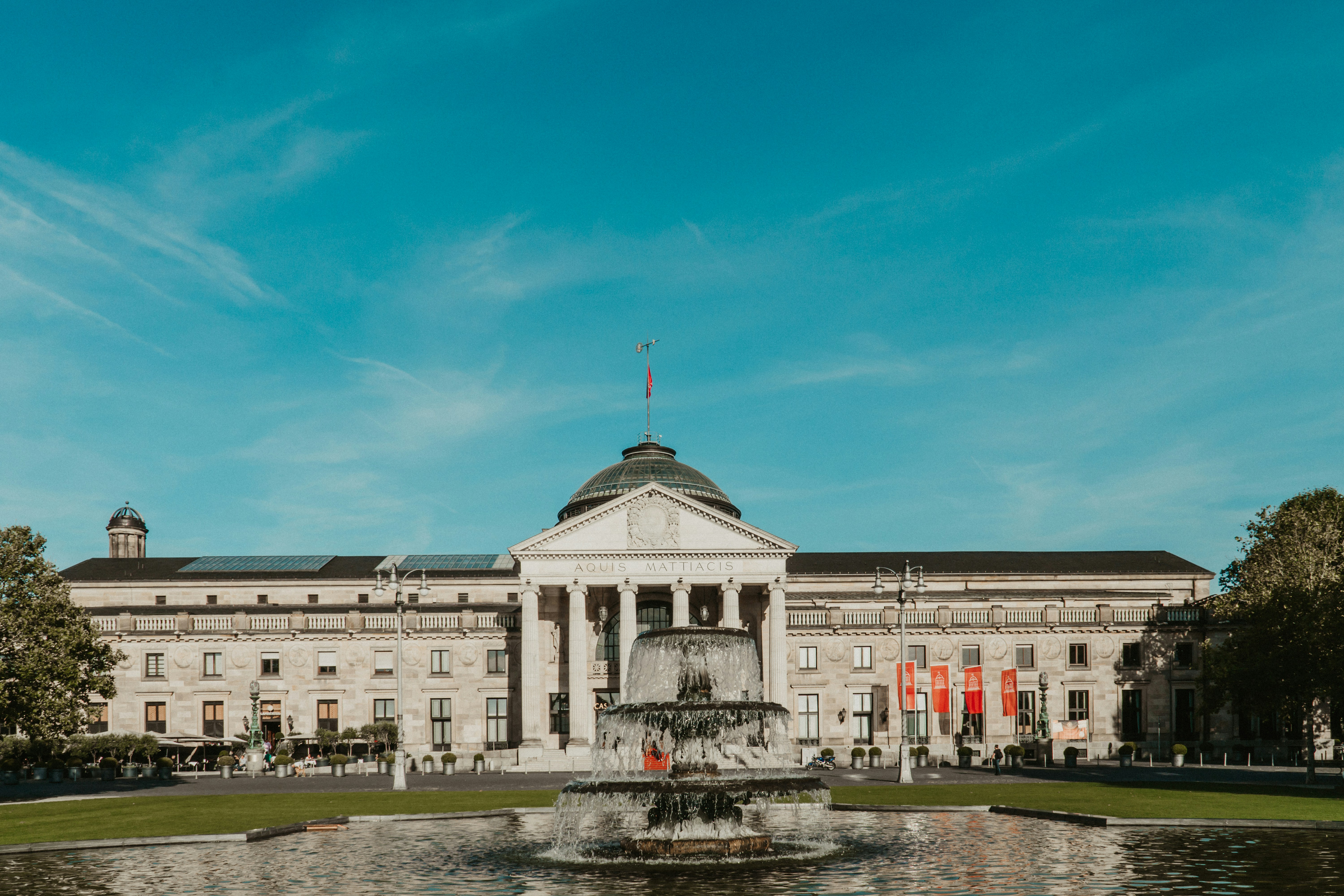 a large building with a fountain in front of it