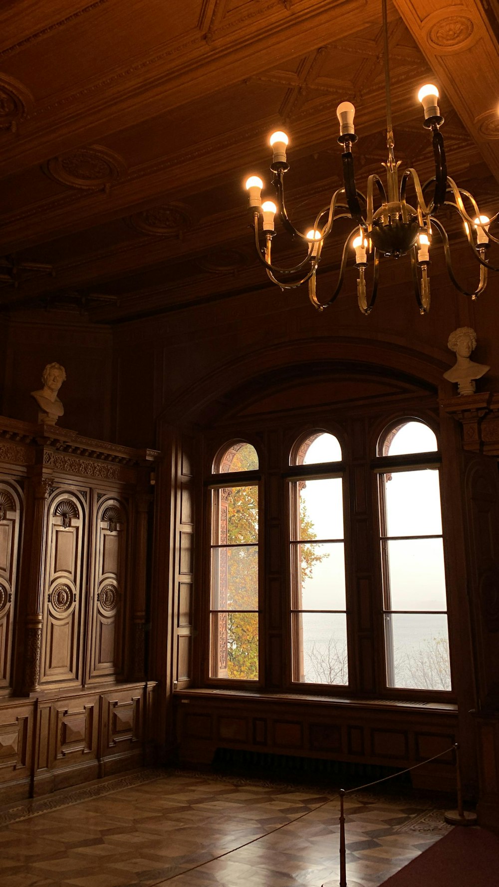 a chandelier hangs from the ceiling in a large room