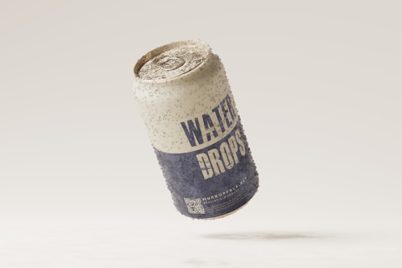 A weathered aluminum can labeled 'WATER DROPS' appears to be floating against a neutral background. The surface of the can is speckled with dirt, giving it a rustic and aged appearance.