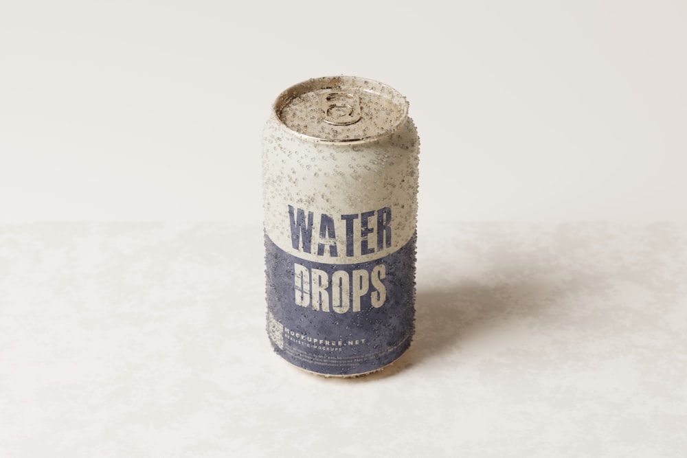 a can of water sits on a white surface