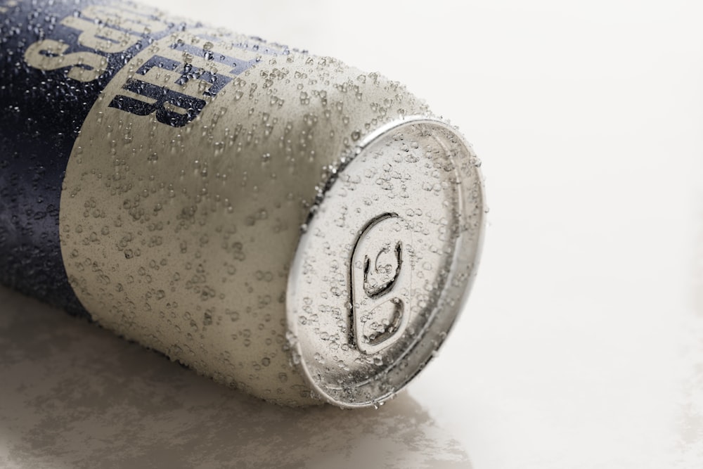 a can of soda sitting on top of a table