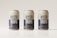 Three beverage cans covered in condensation are aligned in a row against a light, neutral background. The cans are labeled with the words 'Water Drops' in bold blue letters on a white background, with additional text and a QR code near the bottom.