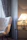 Image of a cozy bedroom corner featuring a sleek armless vanity stool with soft lighting.