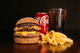 a hamburger, fries and a coke on a table
