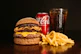 a hamburger, fries and a coke on a table