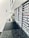 A sleek, modern workspace with a long black countertop. Numerous labeled compartments are neatly organized along the wall, possibly for filing or storage purposes. The setting includes some decorative elements like a small plant arrangement, creating a minimalistic and organized vibe.