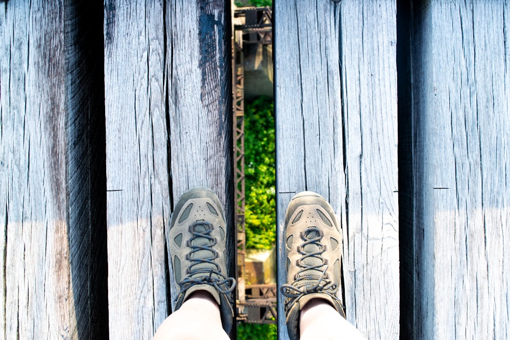 a person standing on a wooden platform with their feet up