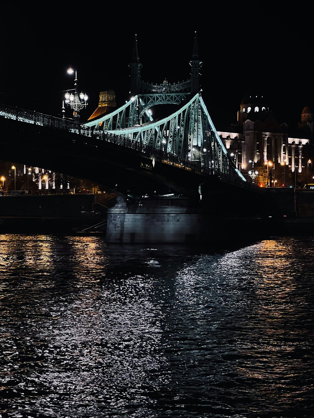 a boat is in the water under a bridge