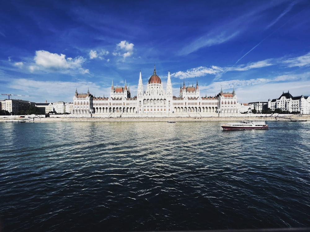 a large white building sitting on the side of a river