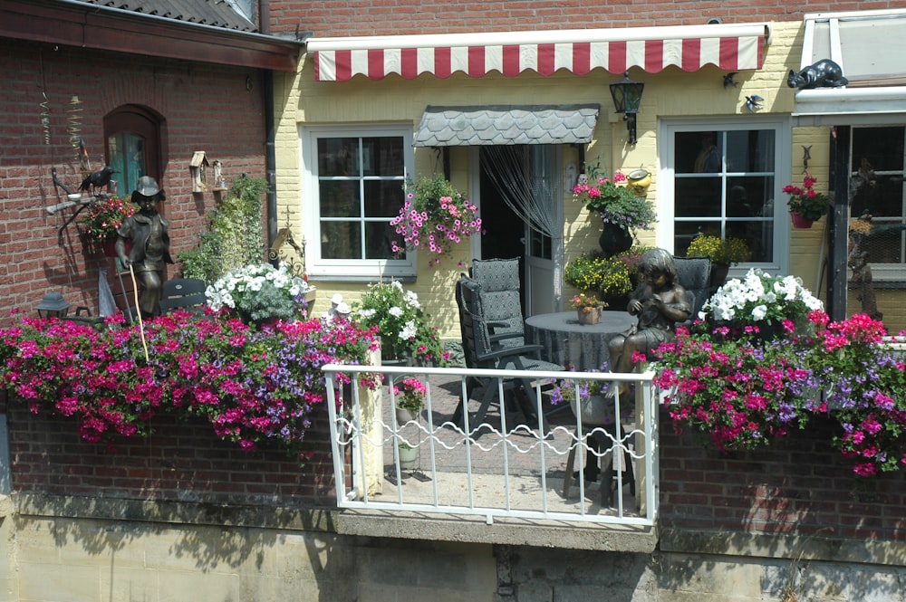 a balcony with a table and chairs covered in flowers