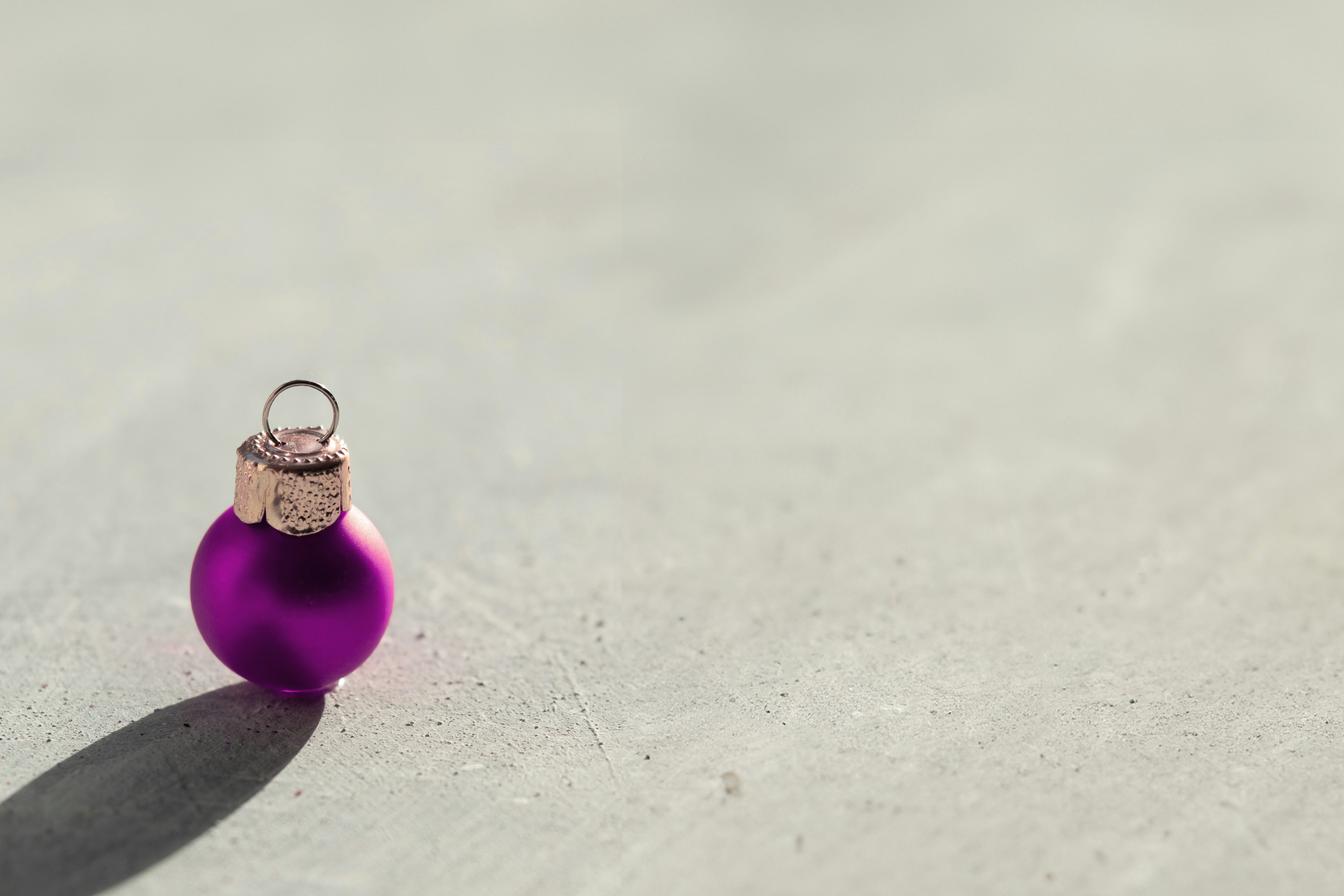 a purple ornament sitting on top of a cement floor