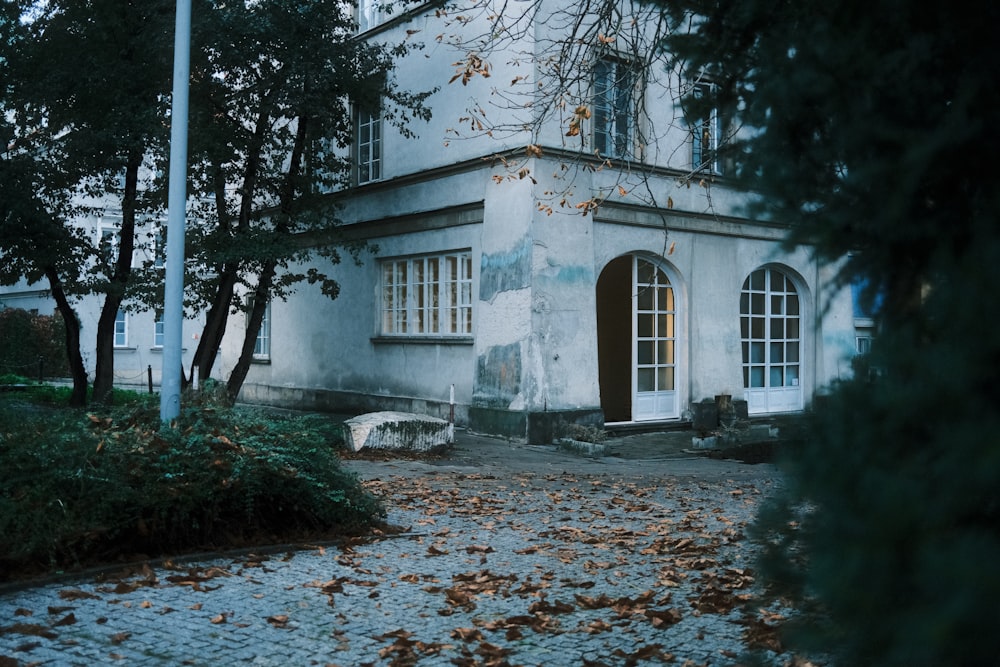 a white house with a tree in front of it