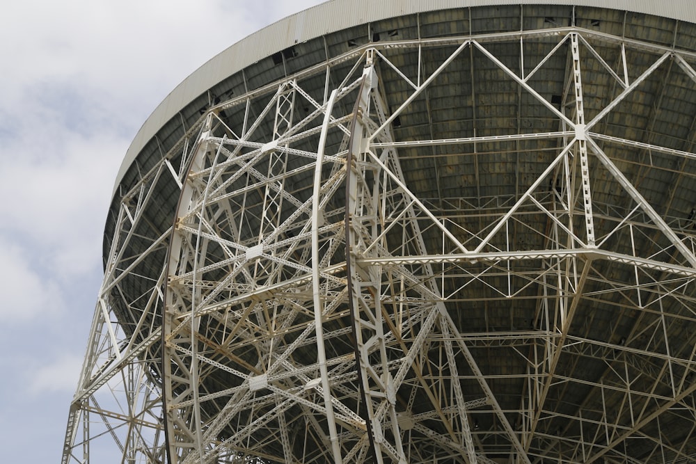 a large metal structure with scaffolding on top of it