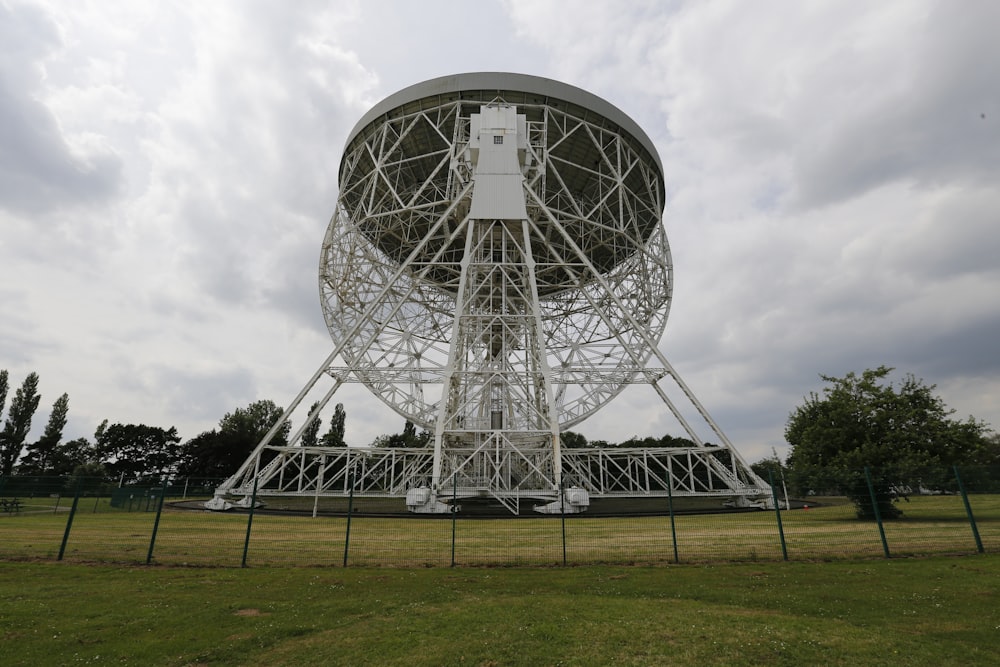 a large metal structure sitting in a field