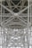 A detailed view of steel trusses forming a complex geometric pattern, showcasing industrial architecture with intersecting beams and rivets.