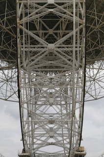 Engineer inspecting a large metal matrix with precision instruments.