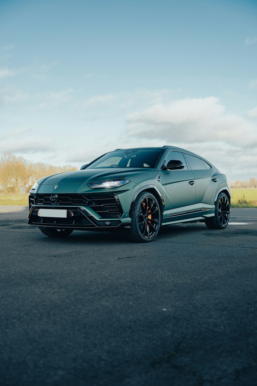 a green sports car parked in a parking lot