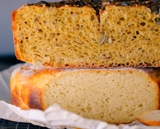 Freshly baked multigrain bread with seeds sprinkled on top, cooling on a linen cloth.