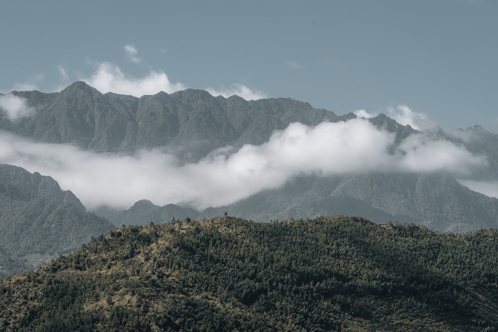 a view of a mountain range with low lying clouds