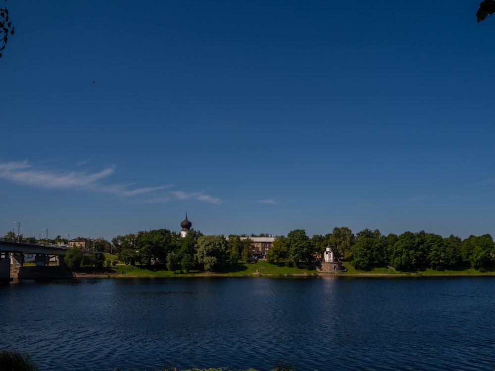 a body of water with a bridge in the background