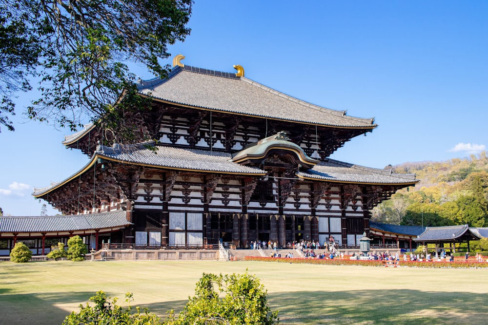 a large wooden building sitting on top of a lush green field