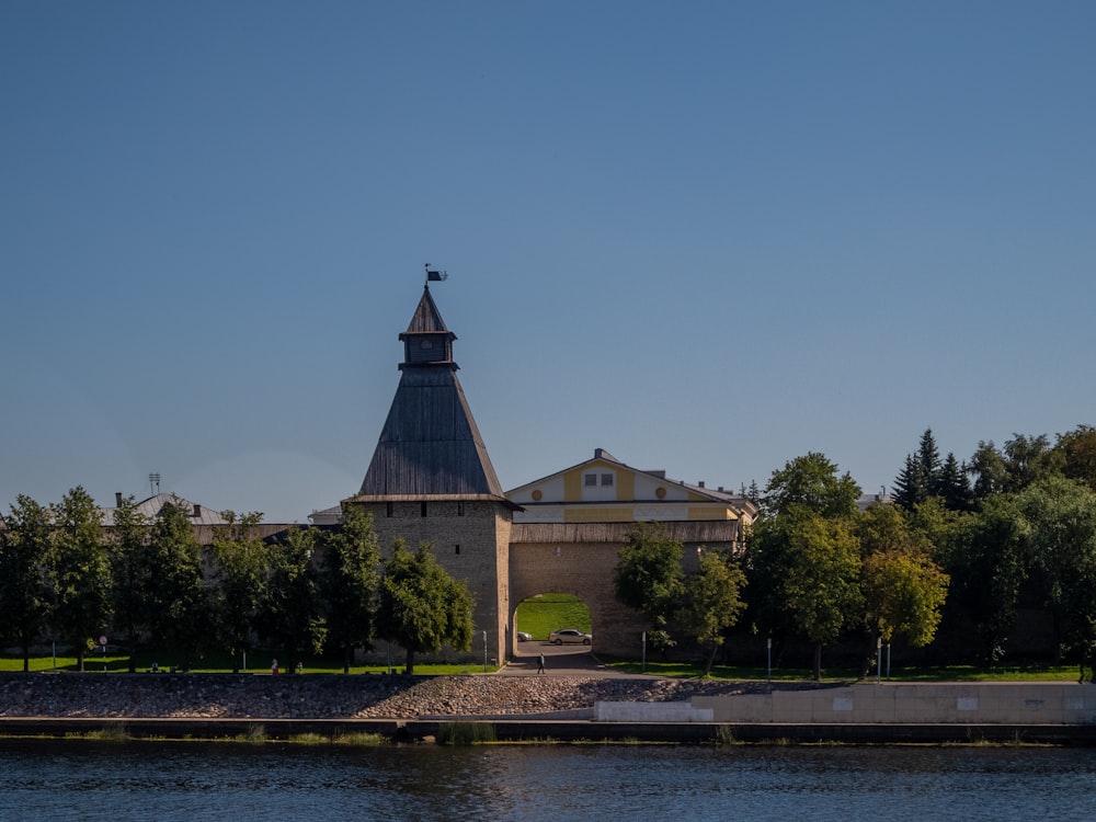 a large building with a tower near a body of water